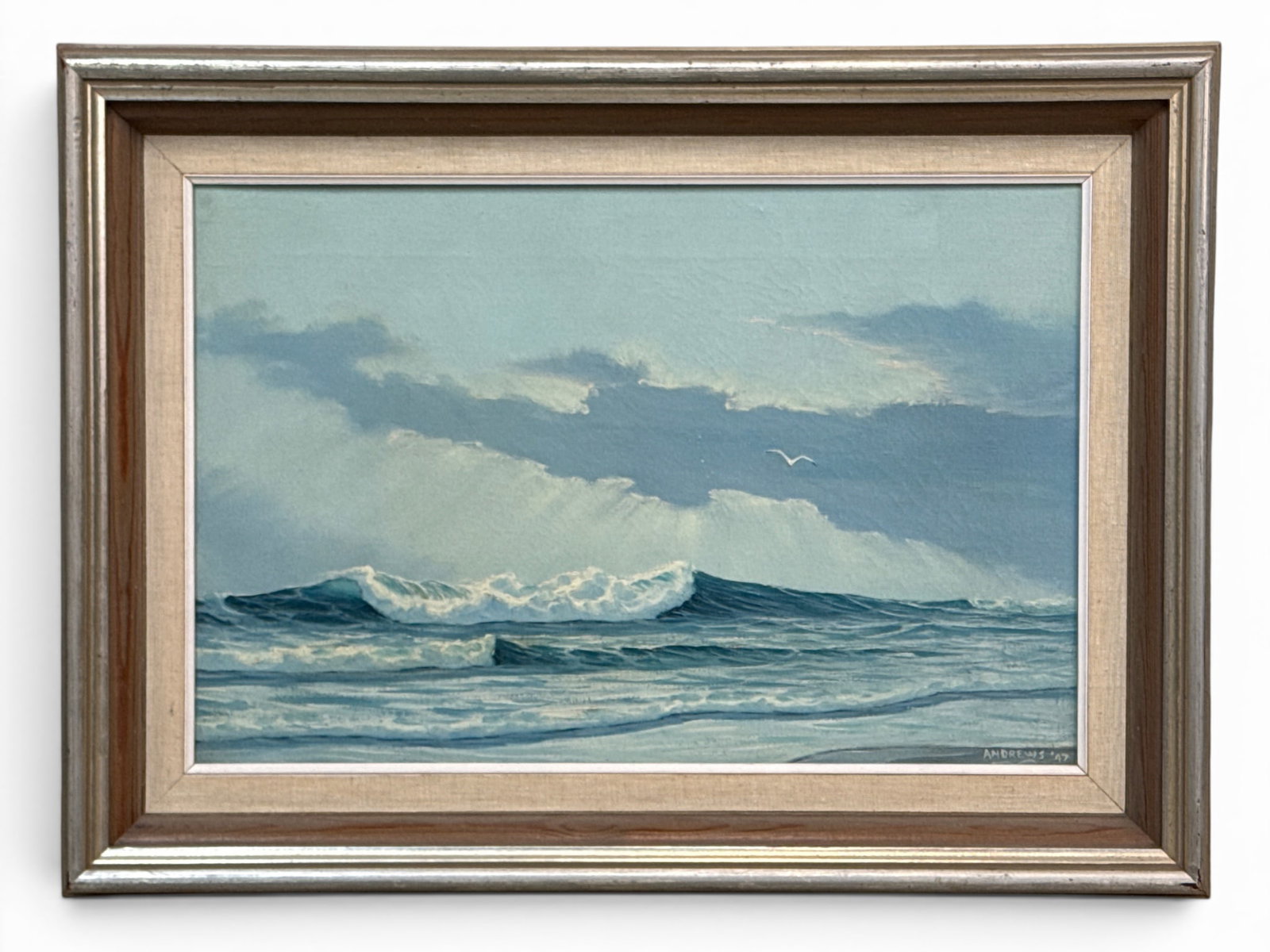 Walter Andrews Oil/Canvas: Surf: Walter Andrews (American, 1905-1969). An oil on canvas seascape depicting breaking surf along a beach shoreline. Signed lower right, dated 47, and framed. Newman Galleries tag verso. Canvas: 12in x 18