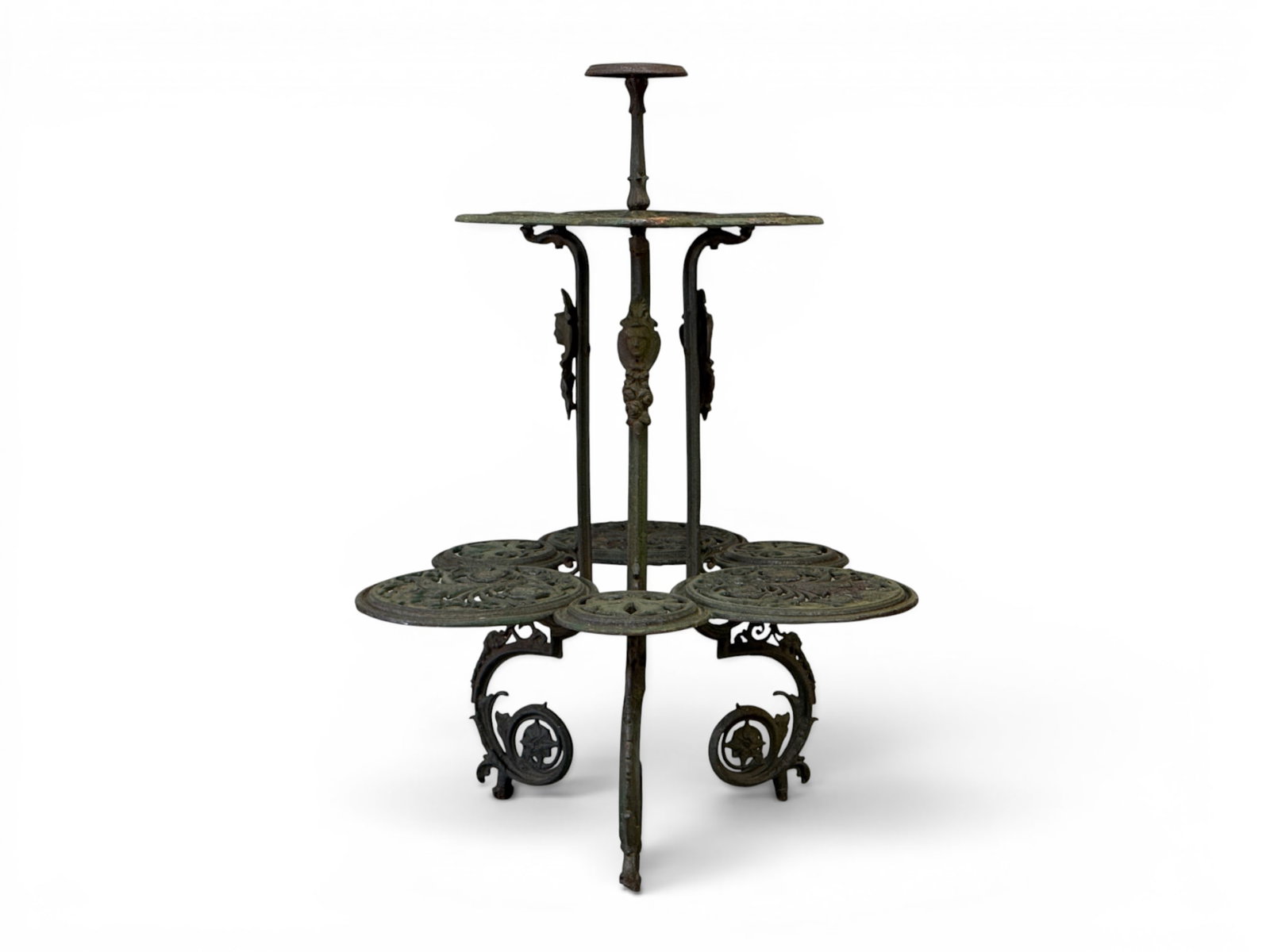 Victorian-style Cast Iron Plant Stand Table: A substantial Victorian-style cast iron flower table plant stand constructed of several tiers with pierced and scrolling design and mask adornment. 44in tall x 31in wide. | You have additional shippin