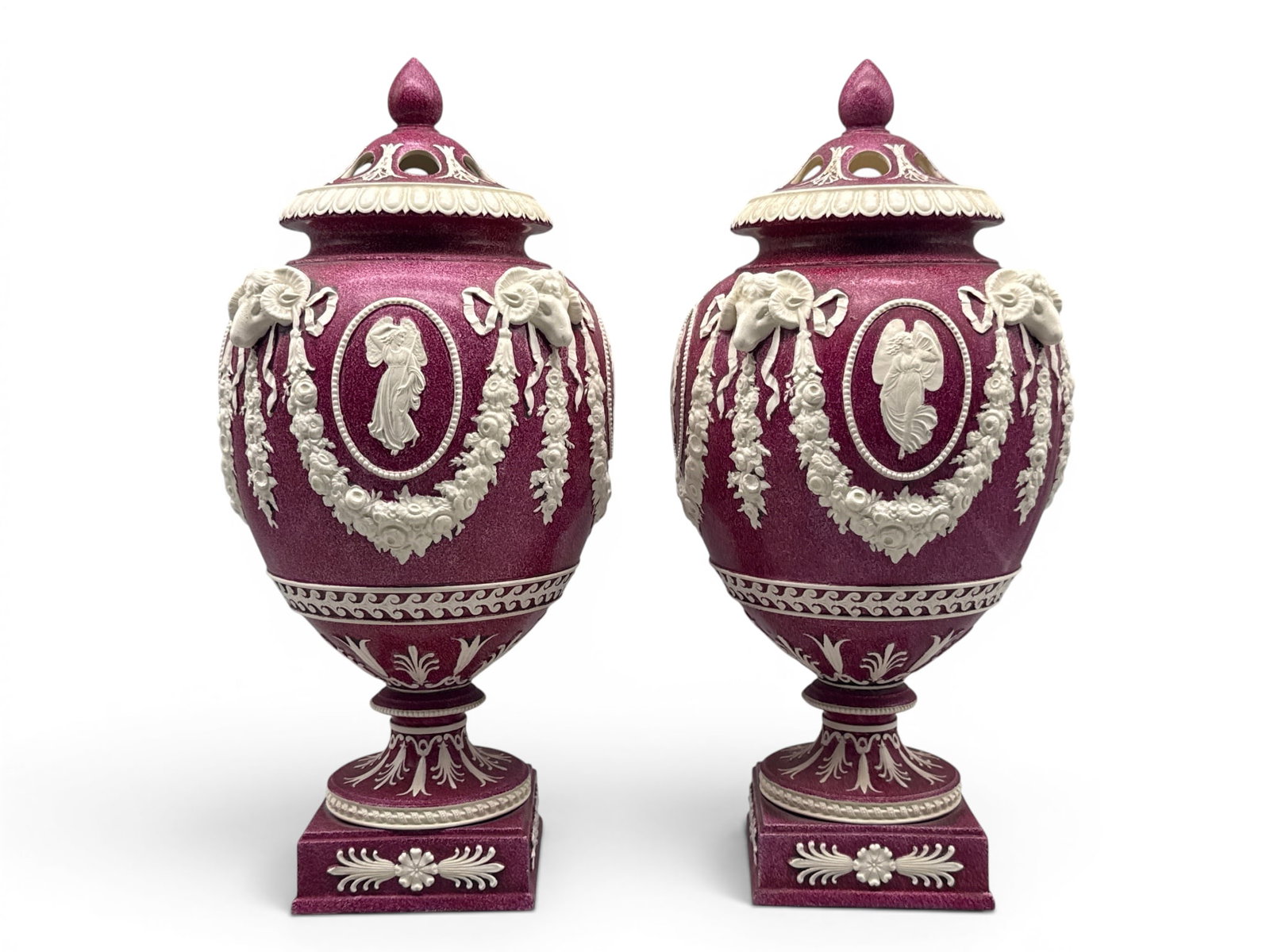 Pr. Wedgwood Queensware Red Potpourri Urns: A pair of Wedgwood Queensware lidded, potpourri urns in powder red with Neoclassical decorations. Impressed marks. 15in tall x 7in wide. Repair to one lid, lacking interior lid on one urn. | You have 