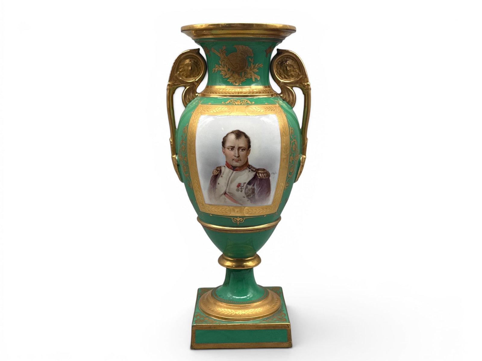 French Empire Sevres Porcelain Napoleon Urn: A French Empire Sevres porcelain urn with a gilt-decorated portrait of Napoleon I on a green background, neoclassical handles, and painted armorial motif. Signed. 14-1/2in tall x 7in wide. | You have 