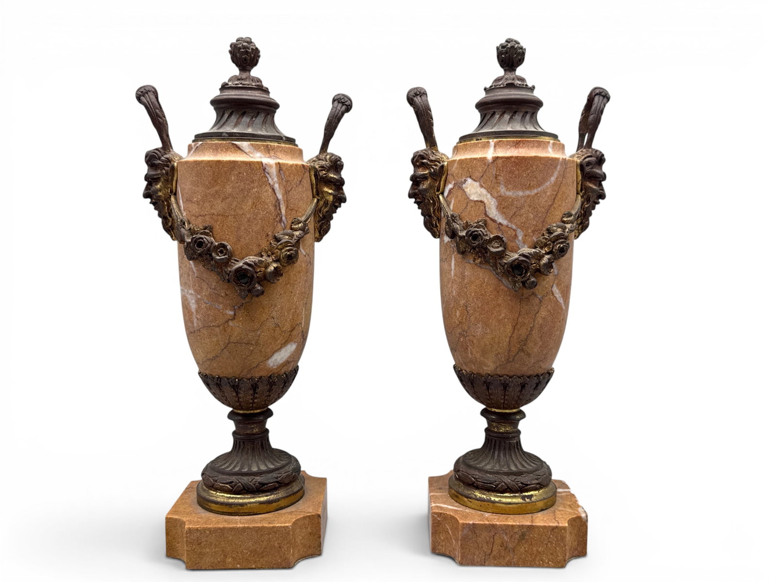 Pair of French Neoclassical Marble and Bronze Urns: A pair of French Neoclassical rouge marble lidded urns with bronze swag laurel decoration and Satyr head handles. 14in tall x 5in wide. | You have additional shipping options, and are not required to 