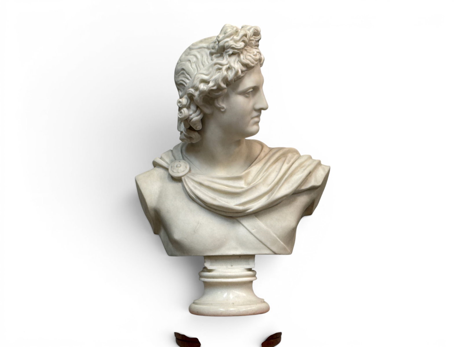 White Marble Bust of the Apollo Belvedere: A carved white marble bust depicting the Apollo Belvedere. 21in tall x 15in wide. | You have additional shipping options, and are not required to use Live Shipping. Additional shipping and delivery de