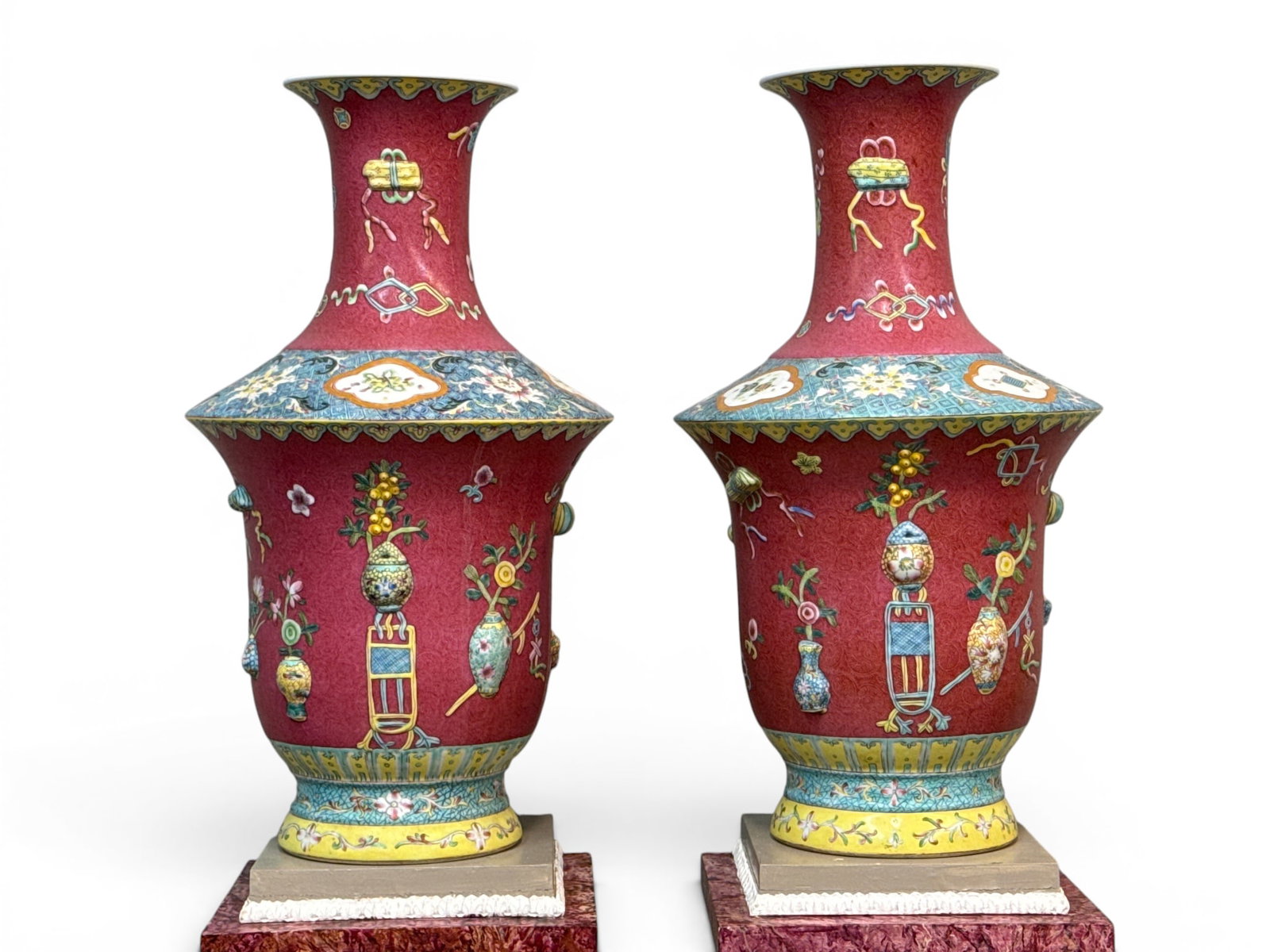 Pair of Large Chinese Famille Rose Porcelain Vases: A pair of large Chinese famille rose porcelain vases with relief vase, urn, and foliate designs. Each with Qianlong seal marks. Approx. 23-3/4in tall x 13in wide. | You have additional shipping option