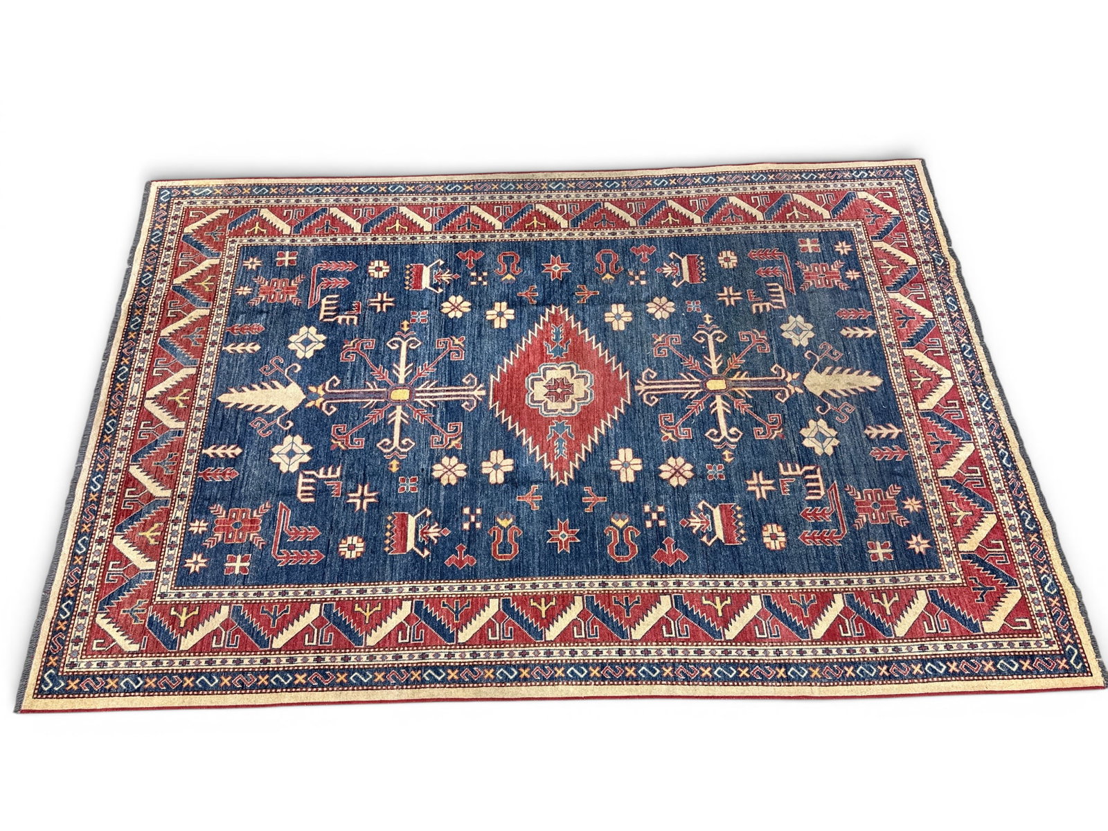 Pakistani Kazak Carpet, 10ft 10in x 7ft 3in: A Pakistani room-size carpet with geometric motifs on a blue ground. 10ft 10in x 7ft 3in. | You have additional shipping options, and are not required to use Live Shipping. Additional shipping and del
