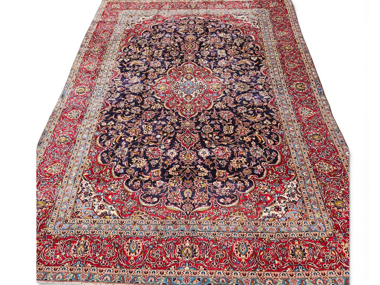 Persian Kashan-style Carpet, 12ft 10 in x 9ft 4in: A Persian Kashan-style room-size carpet with a shaped central foliate medallion. Approx. 12ft 10 in x 9ft 4in. | You have additional shipping options, and are not required to use Live Shipping. Additi