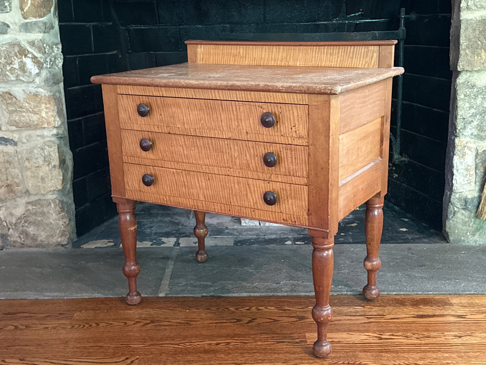 American Sheraton Three-Drawer Server: An American Sheraton server or work table with a gallery back and three drawers with tiger maple fronts, raised on turned legs. Circa 19th C. 32in tall x 30-1/2in wide x 19-1/2in deep. | You have