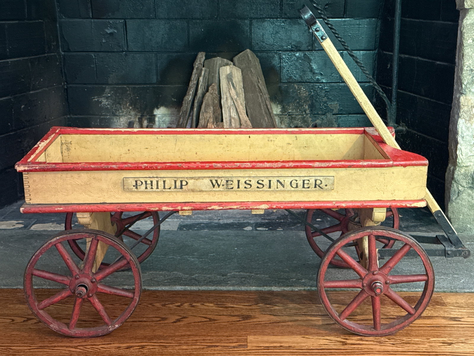 19th C. American Painted Wagon: A 19th C. American painted wagon, with iron-wrapped spoked wheels and stenciled panels "Philip Weissinger". Not including handle: 15-1/2in tall x 34in wide x 18in deep. | You have additional shipping