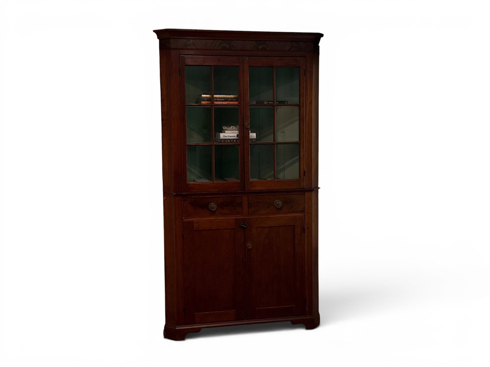 American Mahogany Corner Cupboard: An American mahogany two-part corner cupboard with a two-door glass pane top over a cupboard base on short bracket feet. 82-1/4in tall x 45in wide x approx. 25in deep. | You have additional shipping