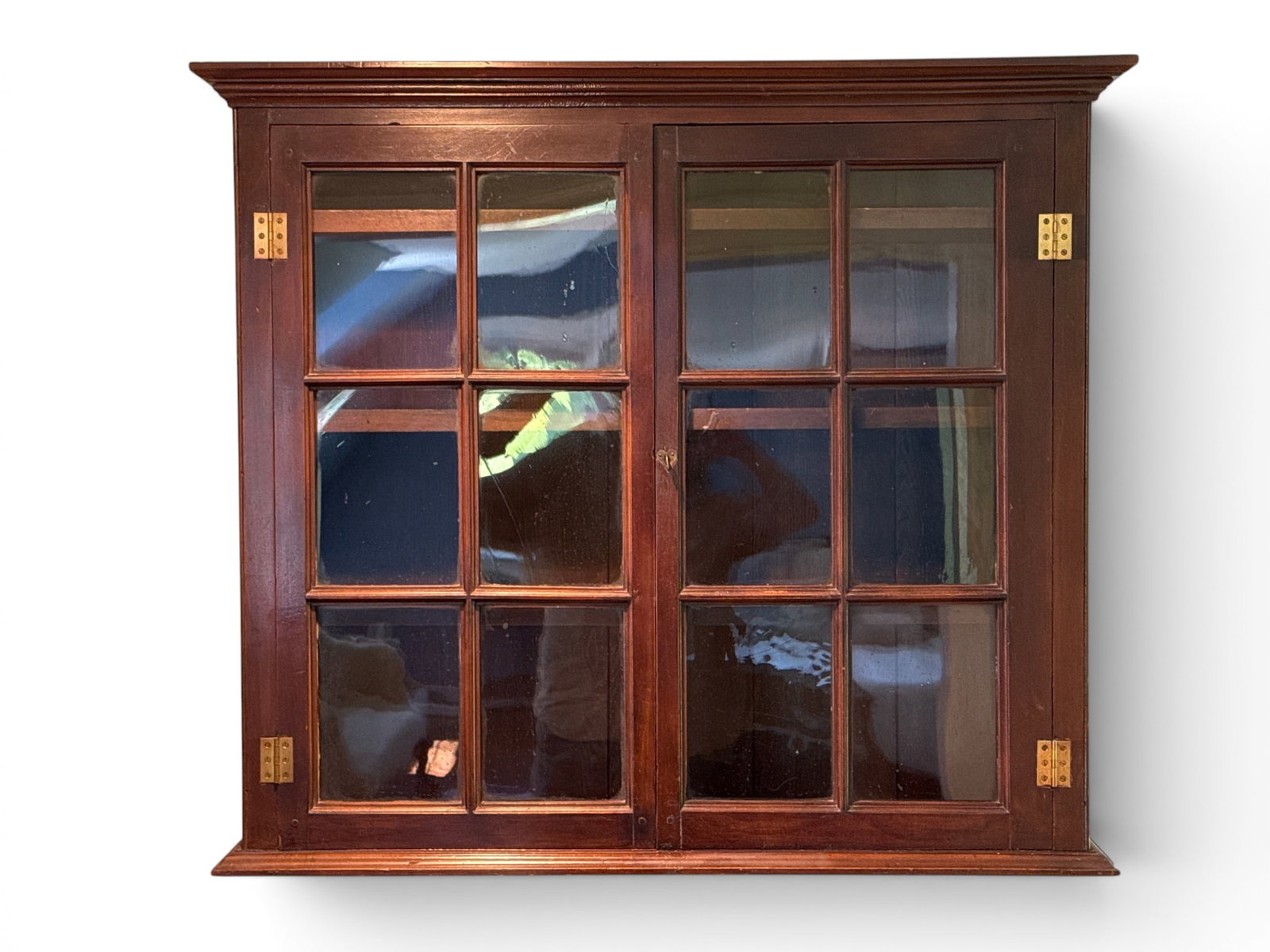 19th C. Mahogany Hanging Wall Cabinet: A 19th C. mahogany hanging wall cabinet having glass paned doors and heart shaped escutcheon. 31-1/4in tall x 35in wide x 8-1/4 in deep. | You have additional shipping options, and are not required to