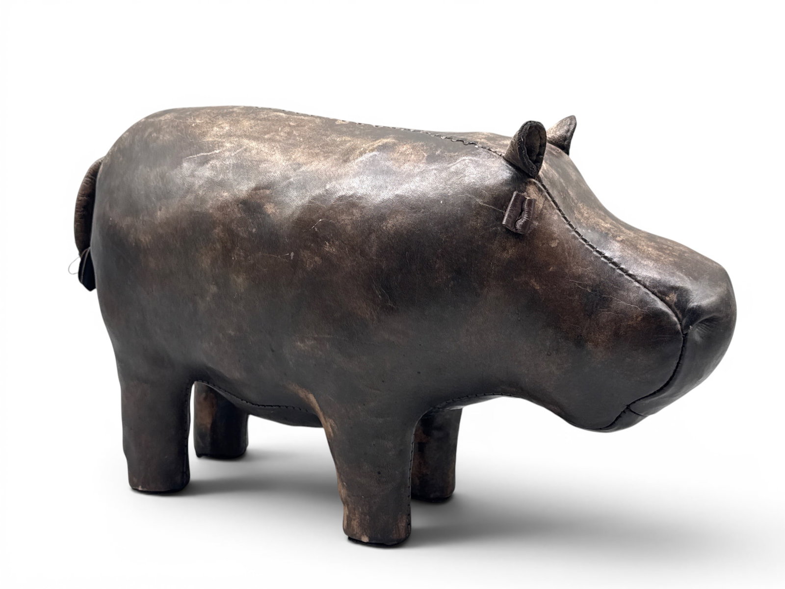 Small Omersa Leather Hippopotamus Footstool: A small Dmitri Omersa brown leather hippopotamus form foot stool with original tag. 11in tall x 17in wide. | You have additional shipping options, and are not required to use Live Shipping. Additional