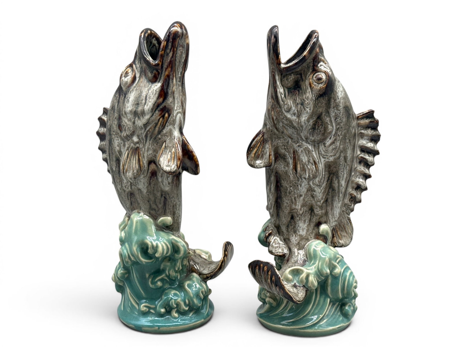 Two Majolica Pottery Fish Form Vases: Two majolica pottery vases modeled after open mouth leaping fish over crashing waves. 13in tall x 4in wide. | You have additional shipping options, and are not required to use Live Shipping. Additiona