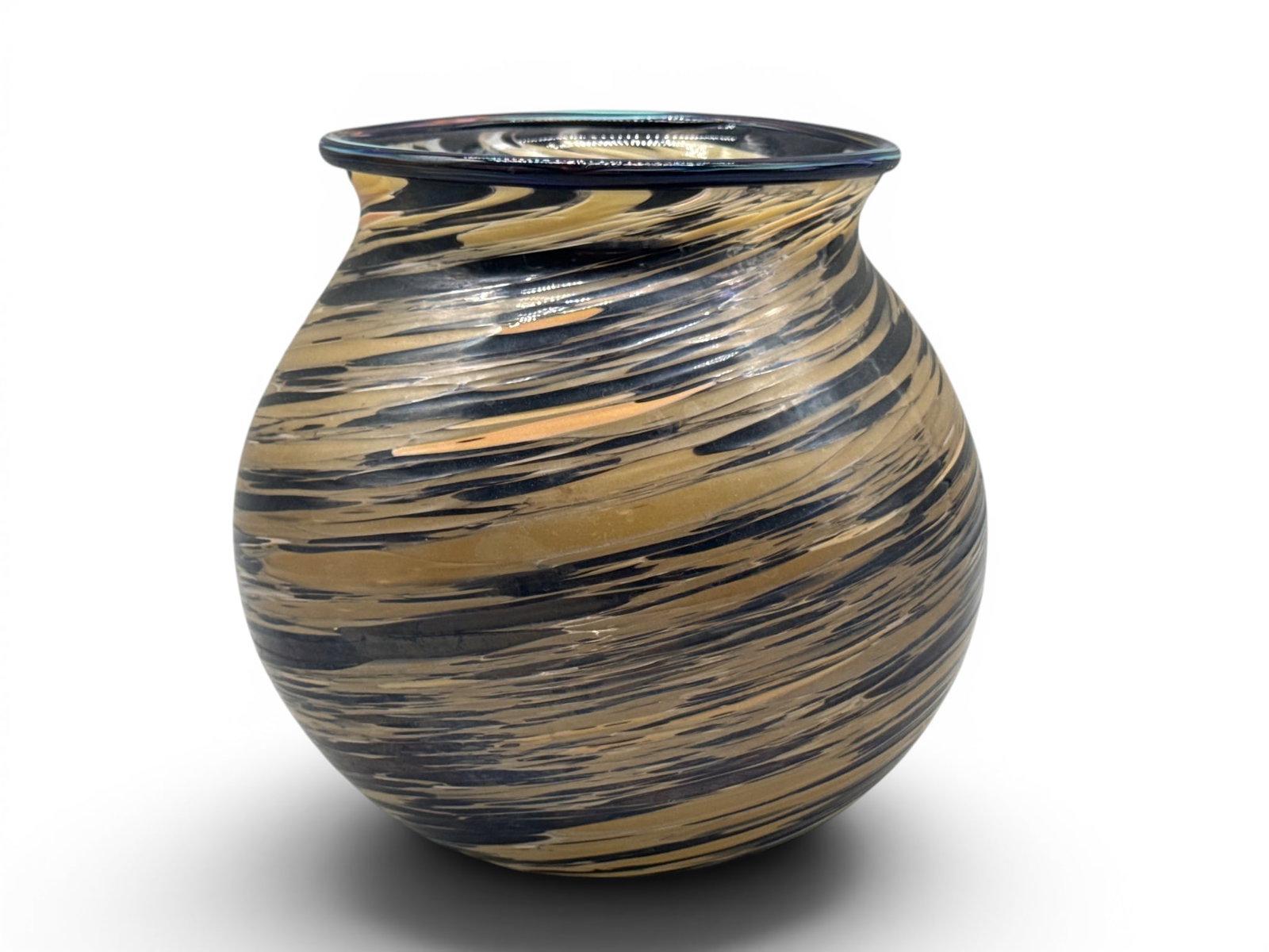 Tony Jojola. Art Glass Vessel.: Tony Jojola (Isleta Pueblo, b. 1958) An art glass vessel having swirled design with bulbous body and tapering neck having blue glass rim. 7-3/4in tall x 7in wide. | You have additional shipping option