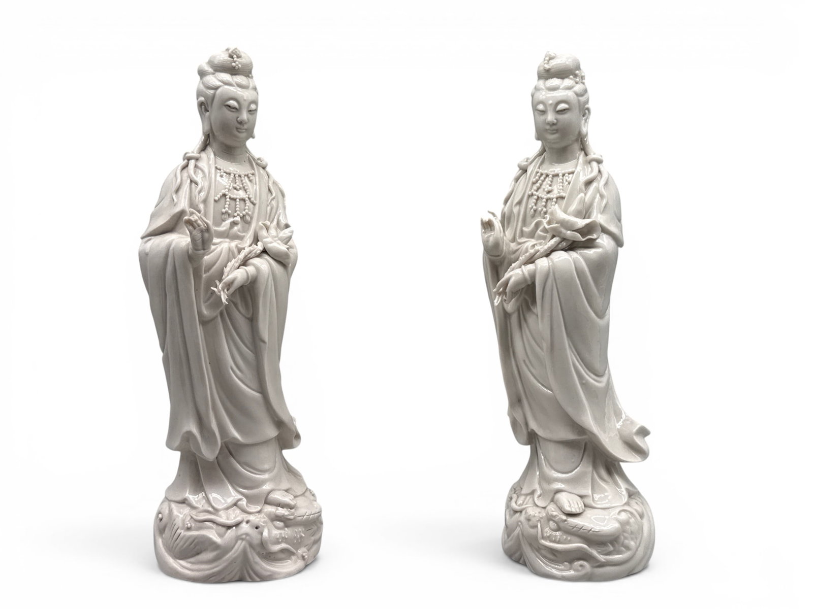 Chinese Blanc de Chine Guanyin Figurines: A pair of Chinese Blanc de Chine Guanyin figurines resting on mythical bases. 11-1/2in tall x 3in wide. | You have additional shipping options, and are not required to use Live Shipping. Additional sh