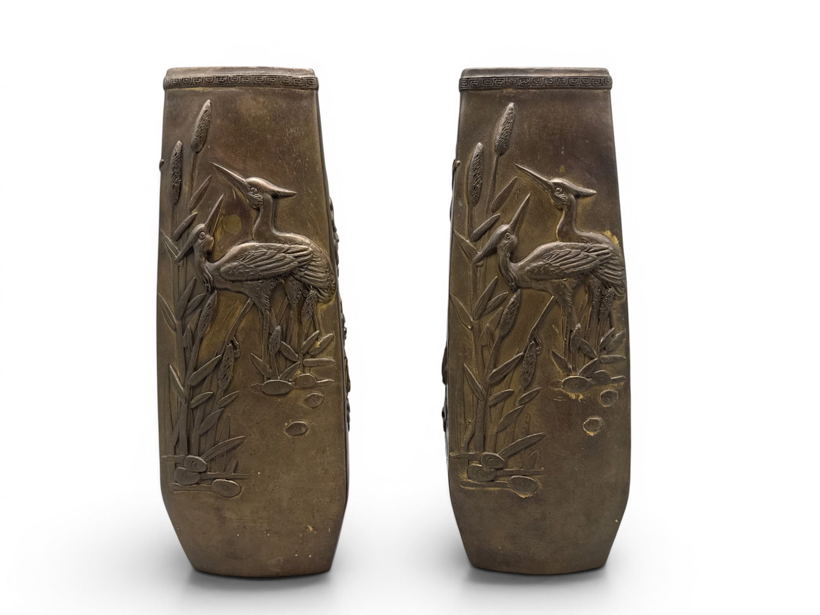 Japanese Bronze Meiji Style Vases: A pair of Japanese bronze triangular form vases in Meiji style having key scroll border around rim and high relief crane, botanical and bird motif. 11in tall x 4in wide. | You have additional
