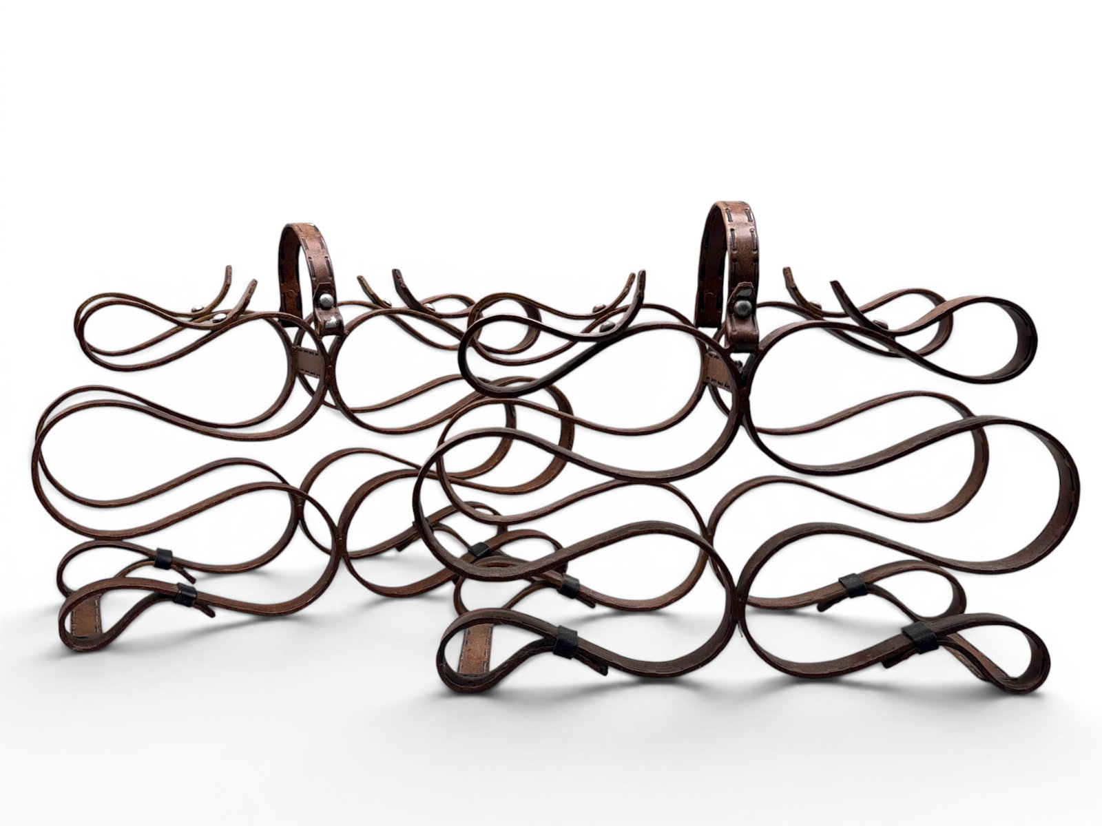 Pair Equestrian Style Iron Wine Racks: A pair of Equestrian style forged iron, Sox bottle wine racks having painted leather decoration with whipstitch detail in the form of horse reins. 13in tall x 16in wide. | You have additional shipping