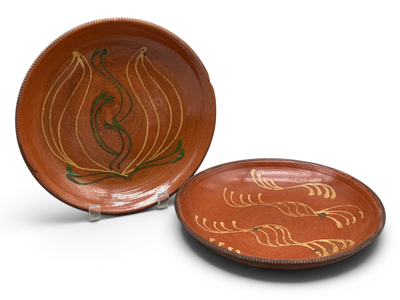 19th C. Slip Decorated Redware Plates: A pair of 19th C. redware plates having yellow slip decoration. Impressed with maker's mark verso. 9-1/2in diameter. | You have additional shipping options, and are not required to use Live Shipping. 