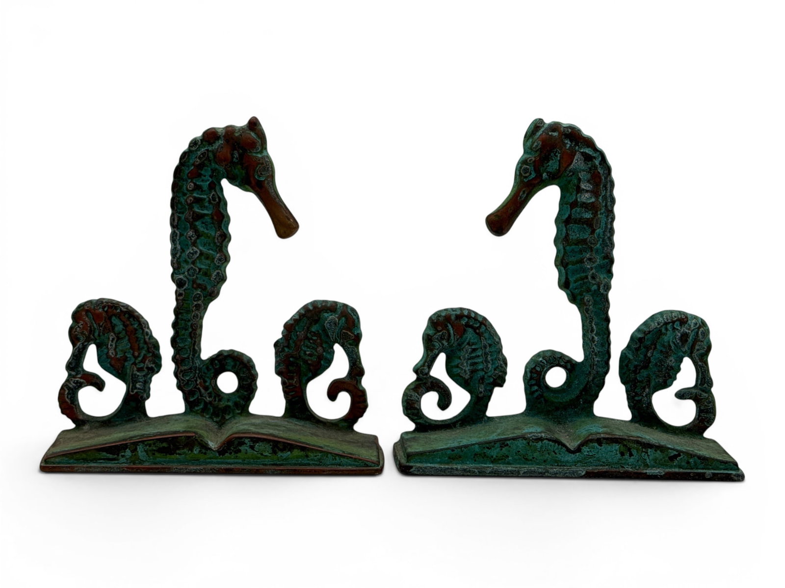 After E.T. Hurley Bronze Seahorse Bookends: A pair of bronze seahorse form bookends with a verdigris patina after E.T. Hurley. 5-1/2in tall x 5-1/2in wide x 1-1/2 in deep. | You have additional shipping options, and are not required to use Live