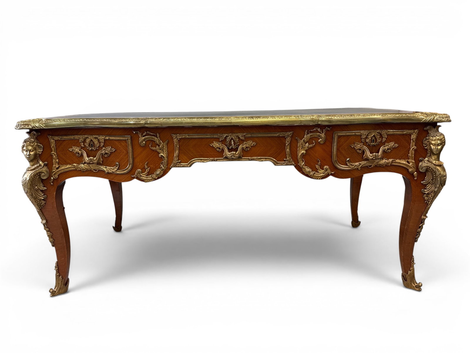 French Louis XV-style Bureau Plat Desk: A French Louis XV-style bureau plat desk having a leather top surface, parquetry case, and ormolu mounts. 31in tall x 69in wide x 37-1/2 in deep. | You have additional shipping options, and are not re