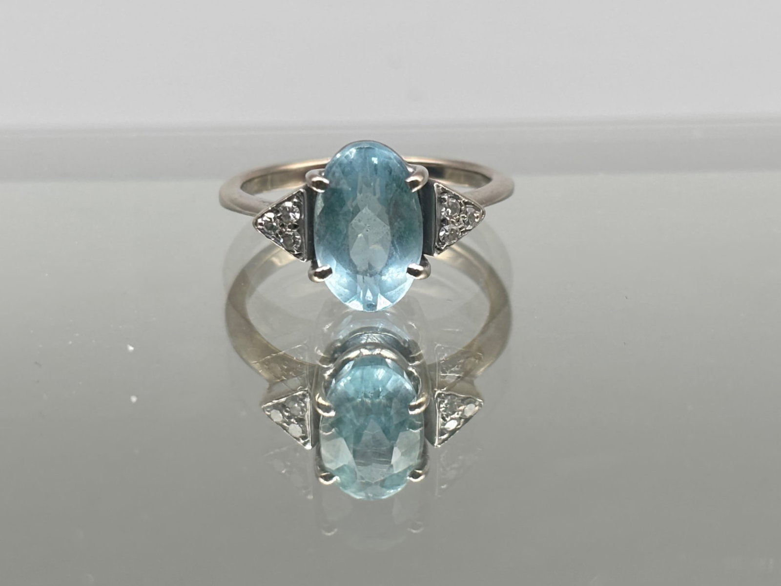 18K Aquamarine and Diamond Ring: A 18K white gold ring with an oval cut 1.7 carat aquamarine flanked by six round cut diamonds. Marked 750. Size 6-1/2. 2.44 dwt. | You have additional shipping options, and are not required to use Liv