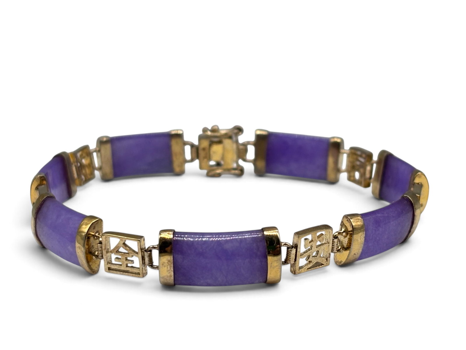 14K Lavender Jade Bracelet: A 14K yellow gold bracelet with lavender jade bars connected by "Good Fortun" filigree motifs. Stamped 585. 8-1/4in long. 10.09 dwt. | You have additional shipping options, and are not required to use