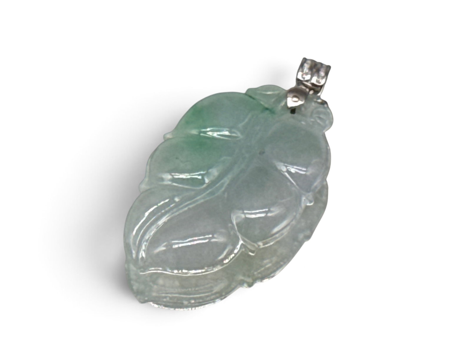 18K Jade Leaf and Diamond Pendant: A carved jade leaf pendant with an 18K white gold mount, set with diamond accents. Marked 18K. 2in tall x 1in wide. 11.18 dwt. | You have additional shipping options, and are not required to use Live 