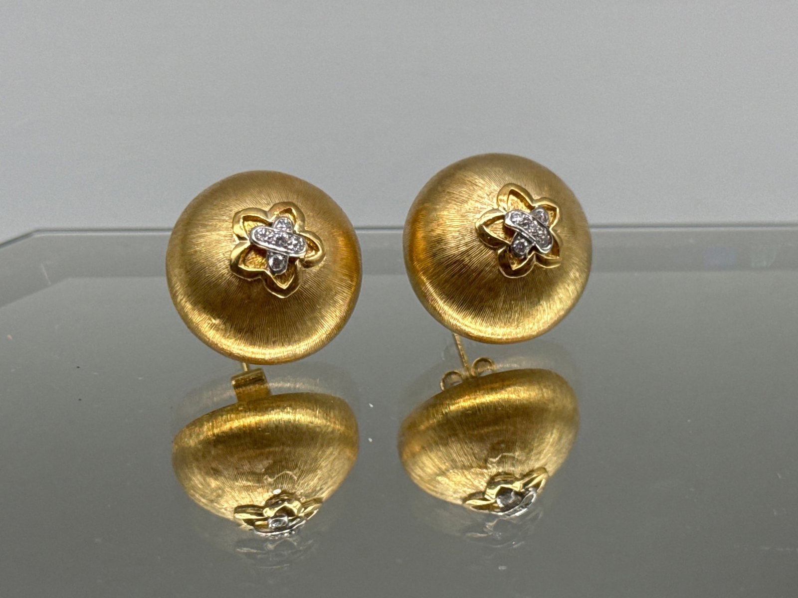 18K and Diamond Domed Flower Earrings: A pair of 18K yellow gold domed earrings with flower decoration and white gold-set diamonds. Marked 750. 3/4in diameter. 7.58 dwt. | You have additional shipping options, and are not required to use L