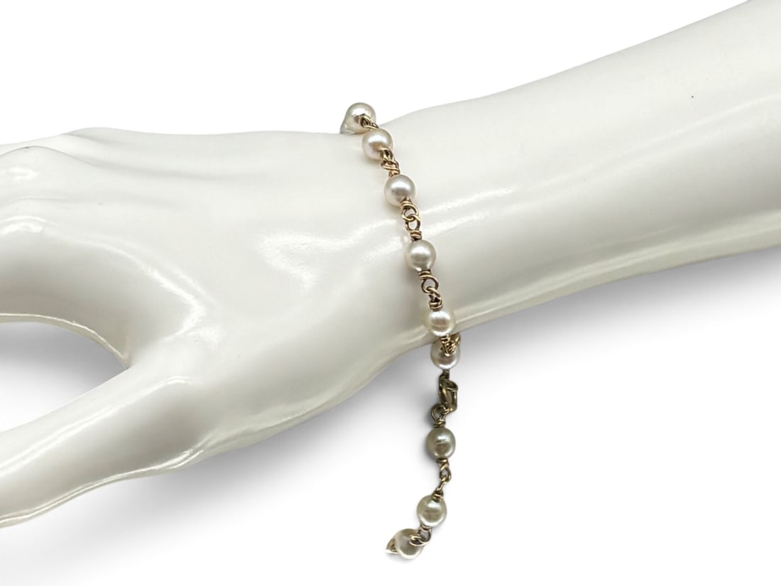 14K Yellow Gold and Pearl Bracelet: A 14K yellow gold link bracelet with 6.0 mm pearls. Marked 14K on clasp. 7-1/2in long. 5.20 dwt. | You have additional shipping options, and are not required to use Live Shipping. Additional shipping 