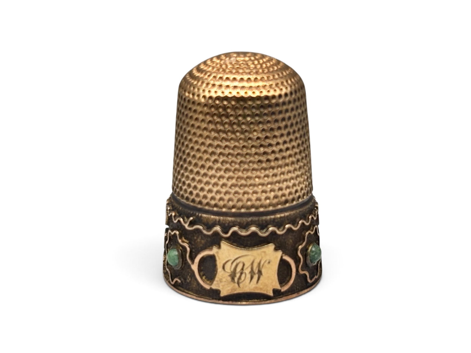14K Victorian Gold and Jade Thimble: A 14K yellow gold Victorian thimble with four jade stones and engraved cartouche "CW". Tests as 14K. 1in tall x 5/8in wide. 2.76 dwt. | You have additional shipping options, and are not required to us