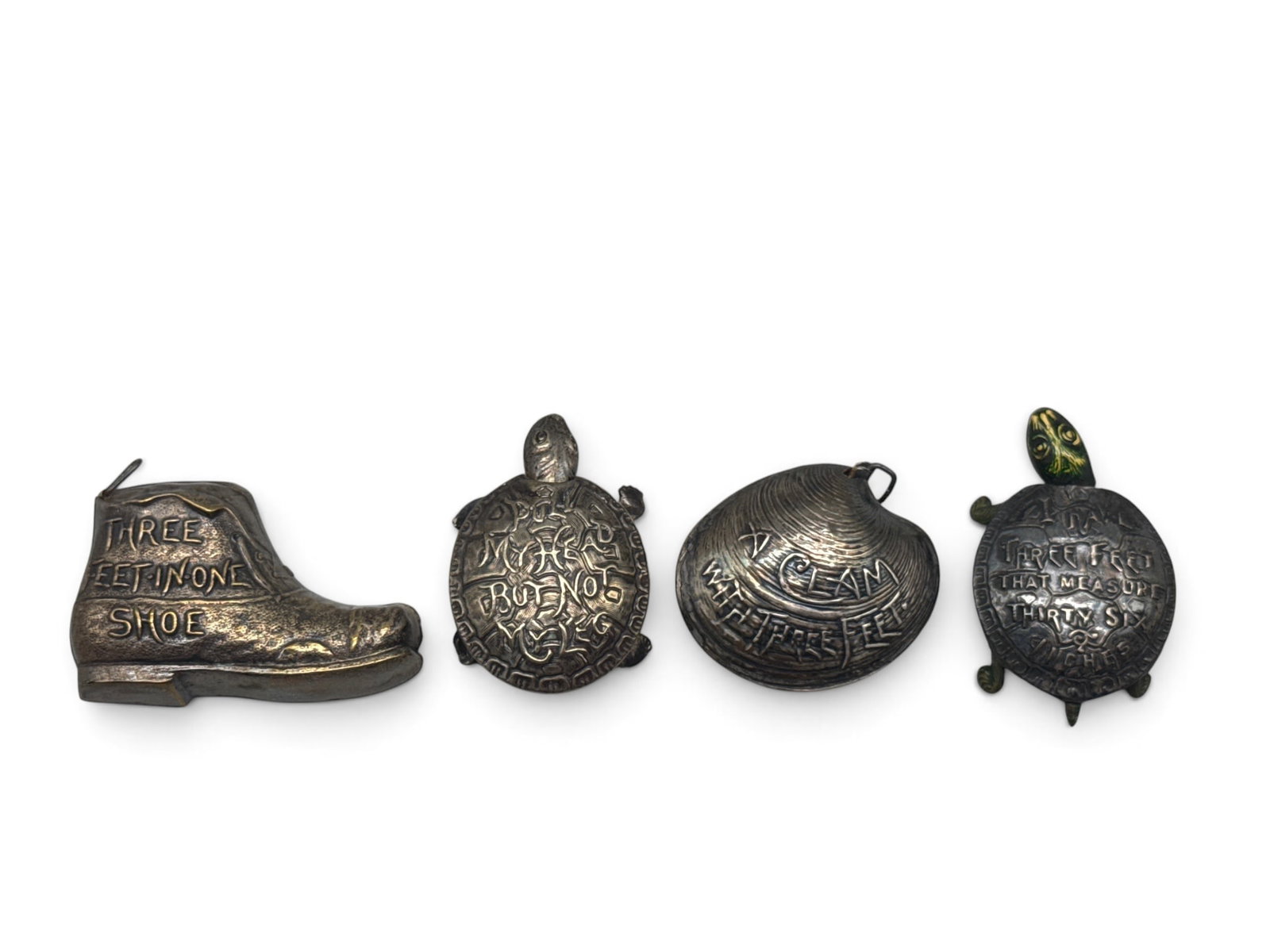 Four Early 20th C. Novelty Measuring Tapes: To include a shoe form declaring "Three Feet in One Shoe"; a clam showing "A Clam with Three Feet"; a turtle saying "Pull My Head but Not My Leg" and a painted turtle with "I Have Three Feet that