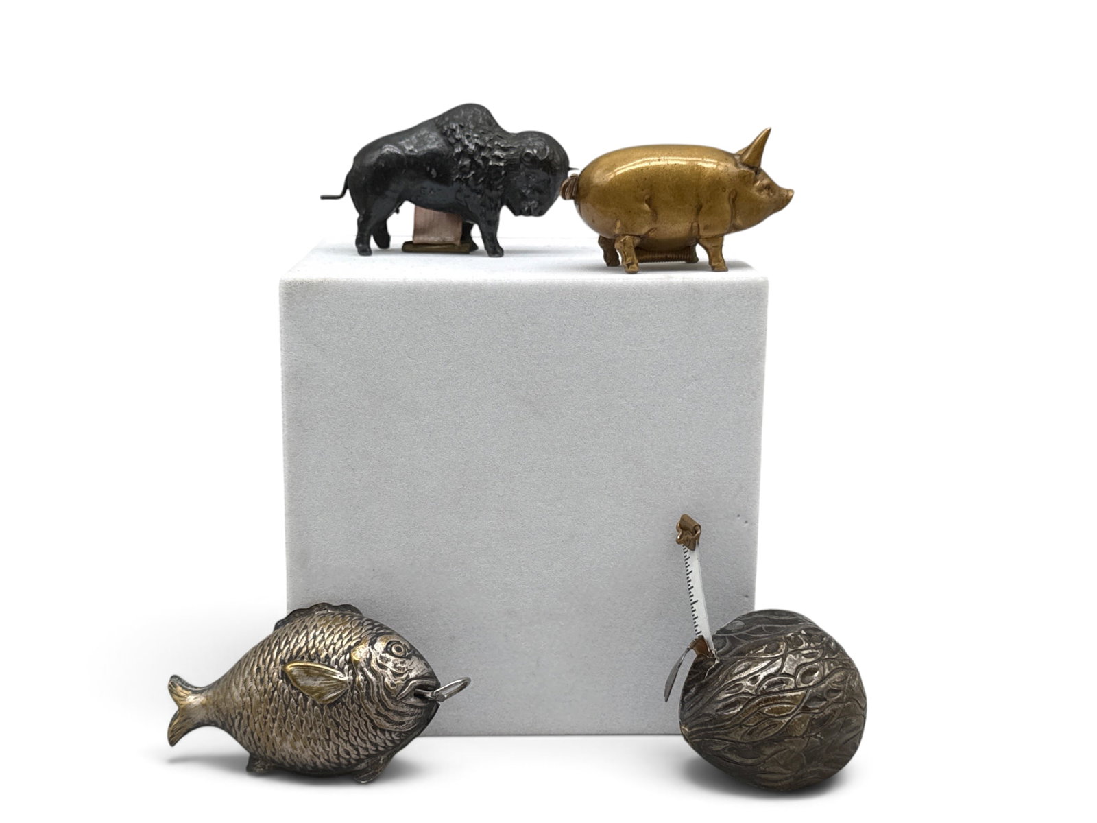Four Figural Novelty Tape Measures: To include a brass fish form, a cast iron buffalo, a bronze piglet, and a walnut. Largest: 1in tall x 2in wide. | You have additional shipping options, and are not required to use Live Shipping.