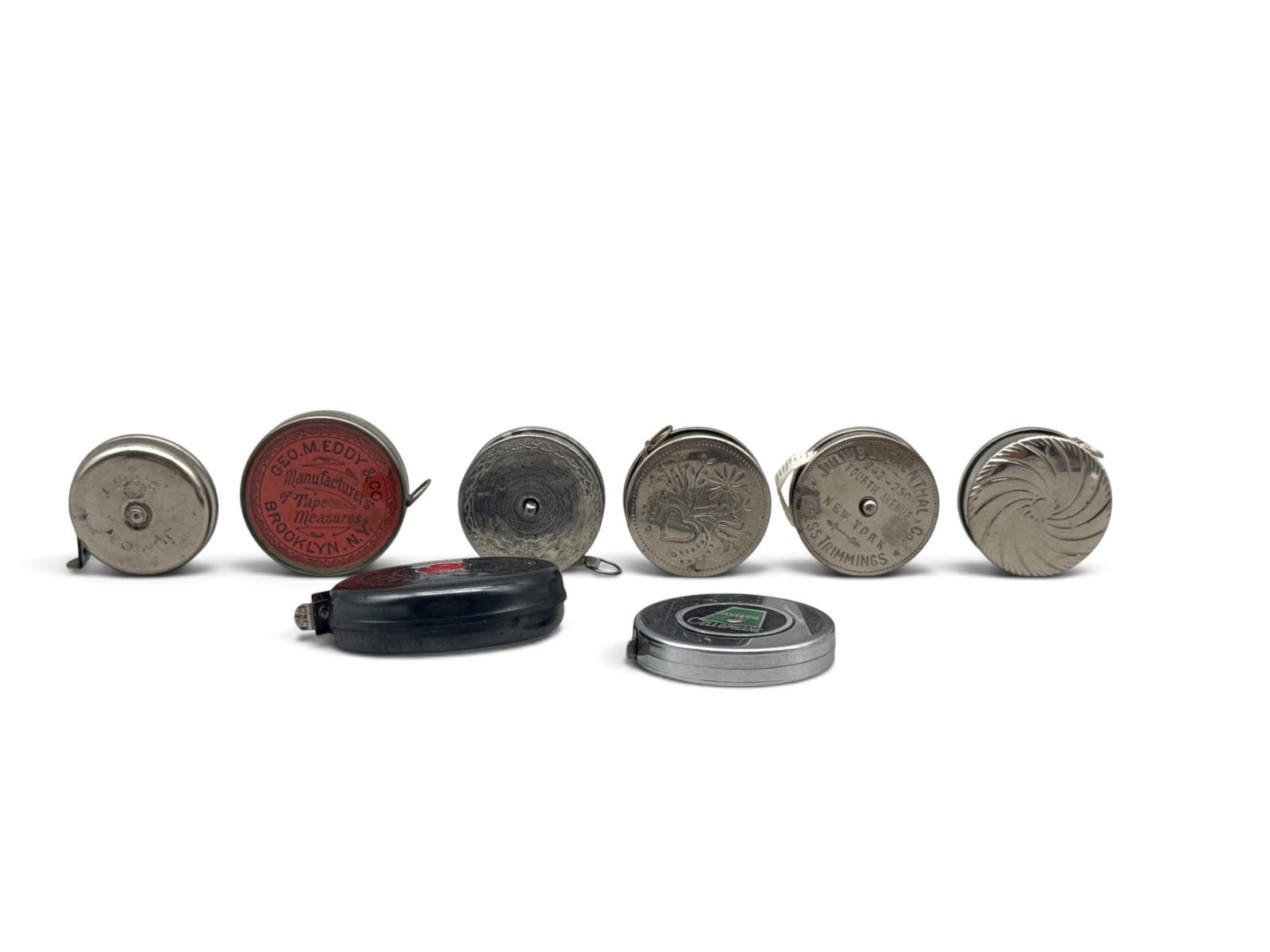Eight Advertising and German Metal Tape Measures: Eight early 20th C. advertising and German metal tape measures. Largest: 2in diameter. | You have additional shipping options, and are not required to use Live Shipping. Additional shipping and