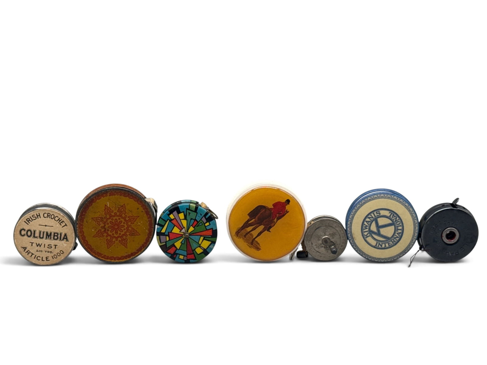 Seven Celluloid and Tin Advertising Tape Measures: Seven celluloid and lithographed tin advertising tape measures. Largest: 2in diameter. | You have additional shipping options, and are not required to use Live Shipping. Additional shipping and delive