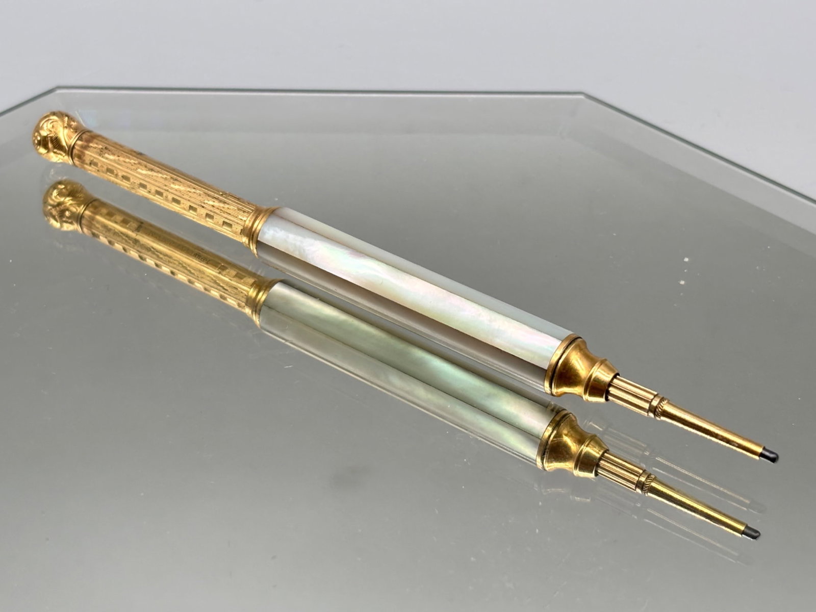 Victorian 14K and Mother of Pearl Retractable Pencil: A Victorian 14K yellow gold telescopic pencil having an engraved gold body with paneled mother of pearl center. Tests as 14K. 5-1/2in long extended; 2-3/4in long when collapsed. 11.83 dwt. | You have