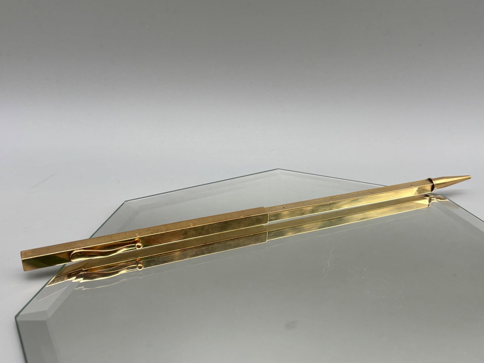 14K Telescopic Pencil and Ruler: A 14K yellow gold telescopic pencil with square-form body that extends into a ruler. Marked 14K. 9-1/2in long at longest; 5-1/2in long compacted. 22.37 dwt. | You have additional shipping options, and