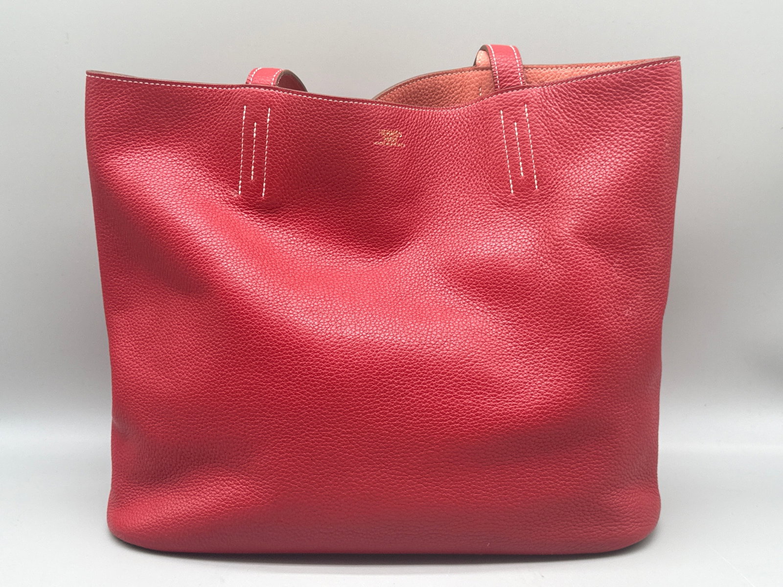 Hermes Double Sens 45 Rouge Leather Tote Bag: An Hermes Double Sens 45 Clemence leather tote bag with rouge exterior, casaque pink interior, and whipstitched handles. Marked Hermes. Includes original dust cloth and Hermes gift box. 12in tall x 16