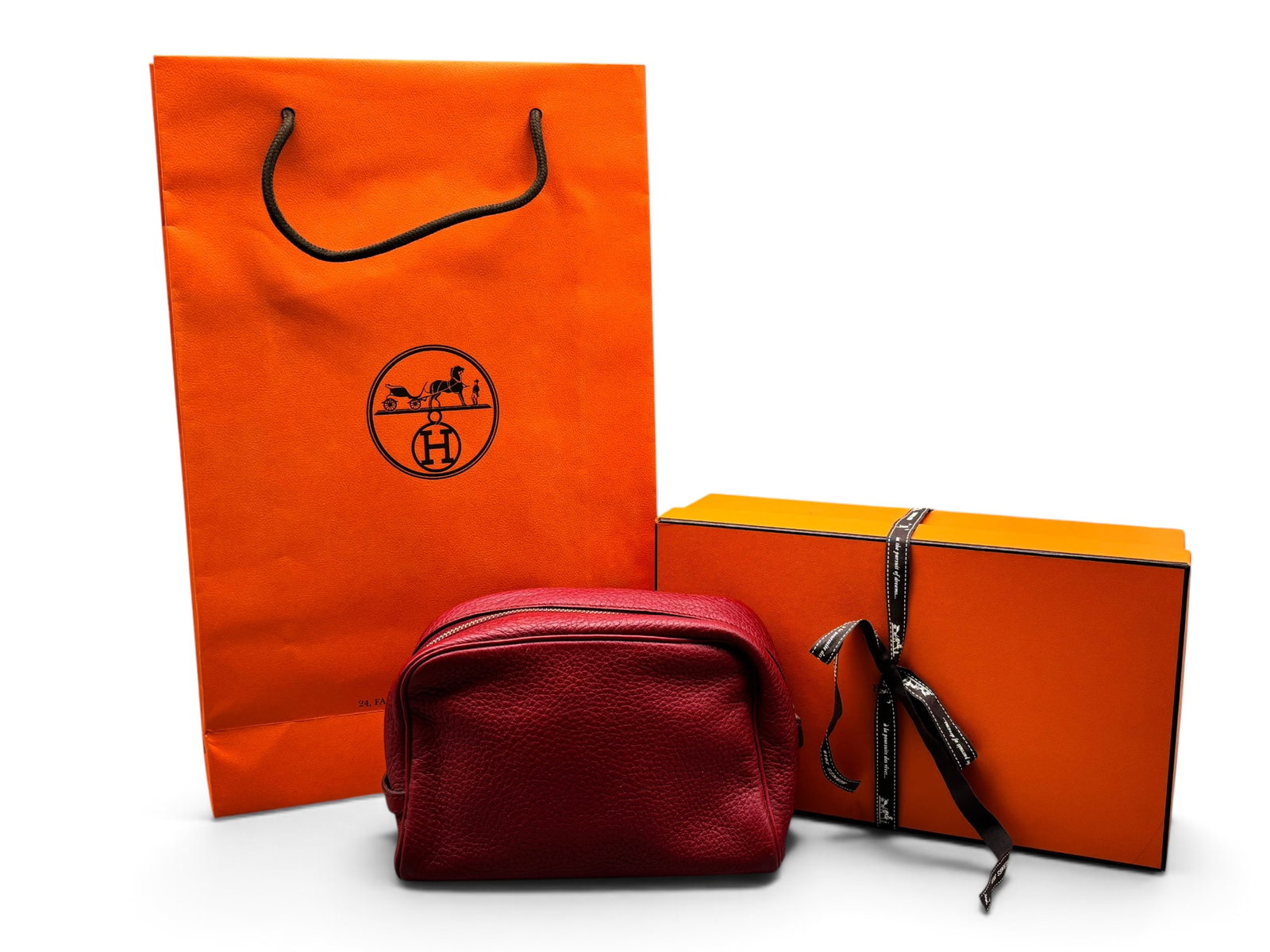 Hermes Trousse Victoria Red Leather Pouch: An Hermes Trousse Victoria leather pouch in red with Hermes branded zipper and nylon interior. Interior is marked Hermes Paris. Includes Hermes box, ribbon, and shopping bag. Pouch: 5in tall x 8in wid