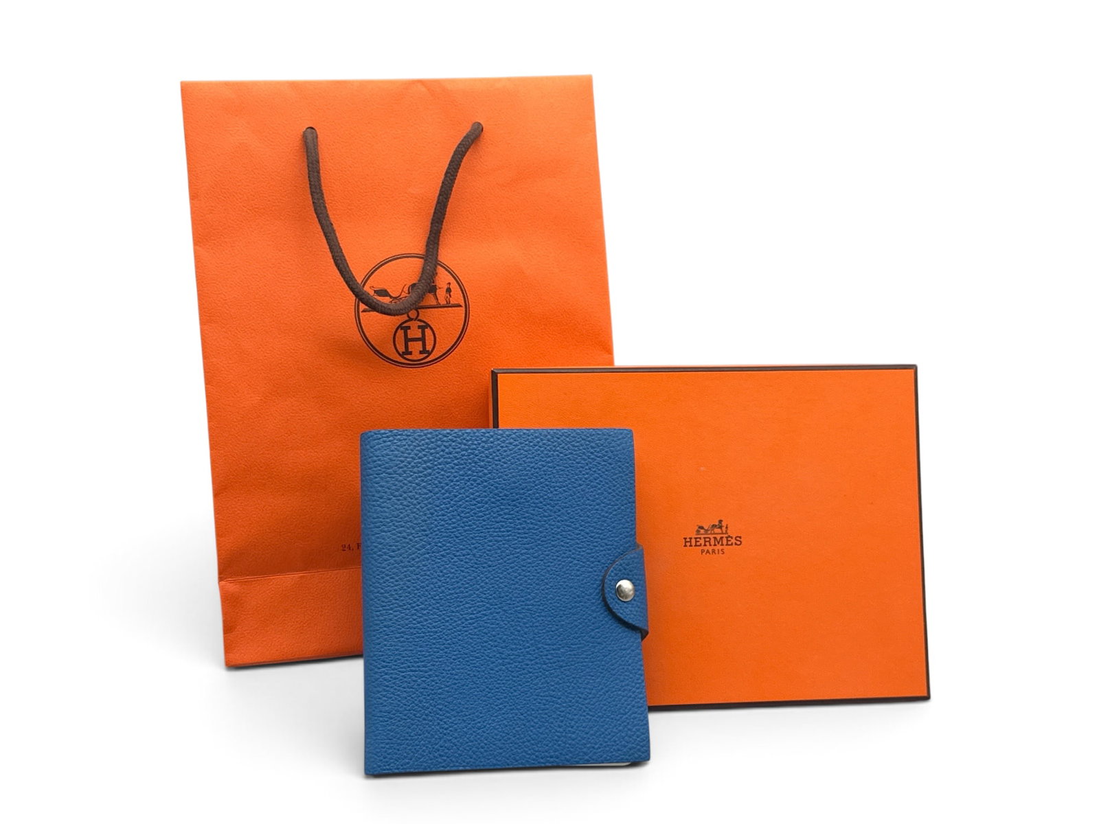 Hermes Ulysse PM Notebook Cover: An Hermes Togo Ulysse PM leather notebook cover in Bleu Electrique. Marked Hermes on interior. Includes original box and Hermes shopping bag. 7in tall x 5in wide. | You have additional shipping option