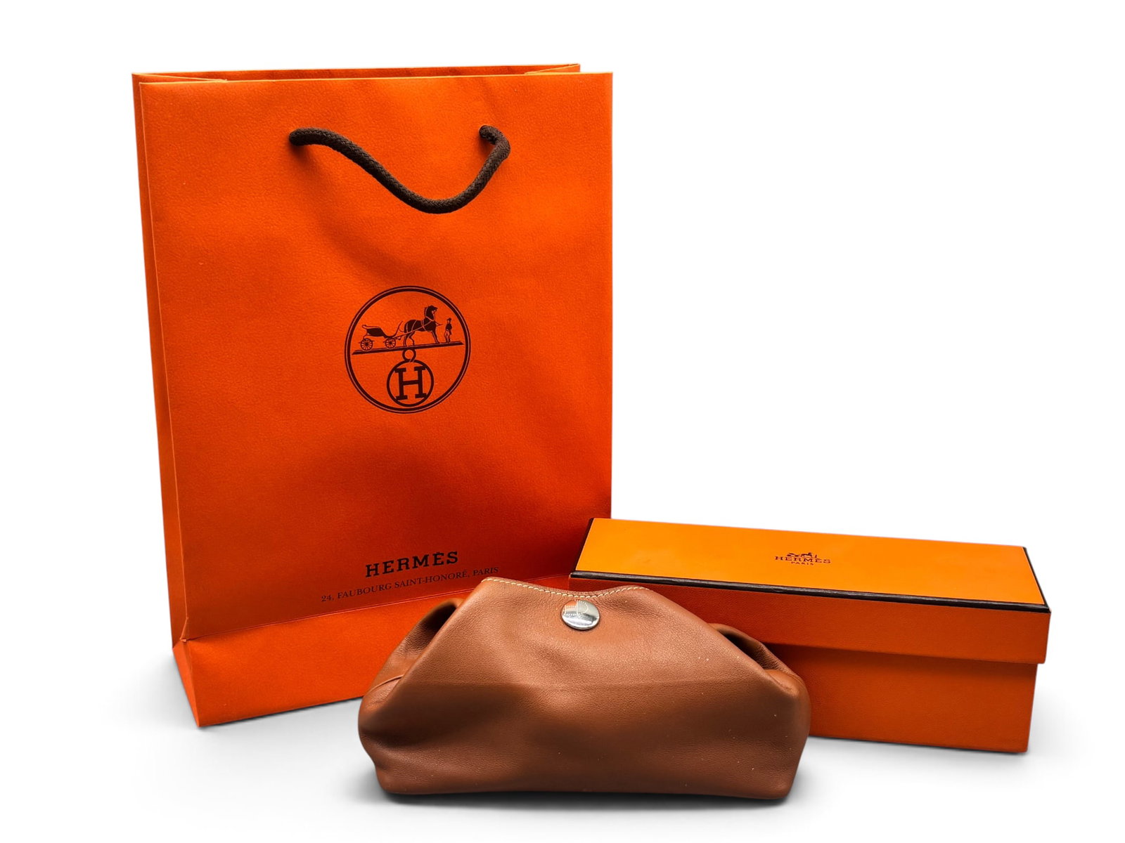 Hermes Bepop Cognac Leather Pencil Pouch: An Hermes Bepop cognac leather fold-over pouch with palladium snap closure. Marked Hermes on interior. Includes original box and shopping bag. 3in tall x 7in wide. | You have additional shipping optio