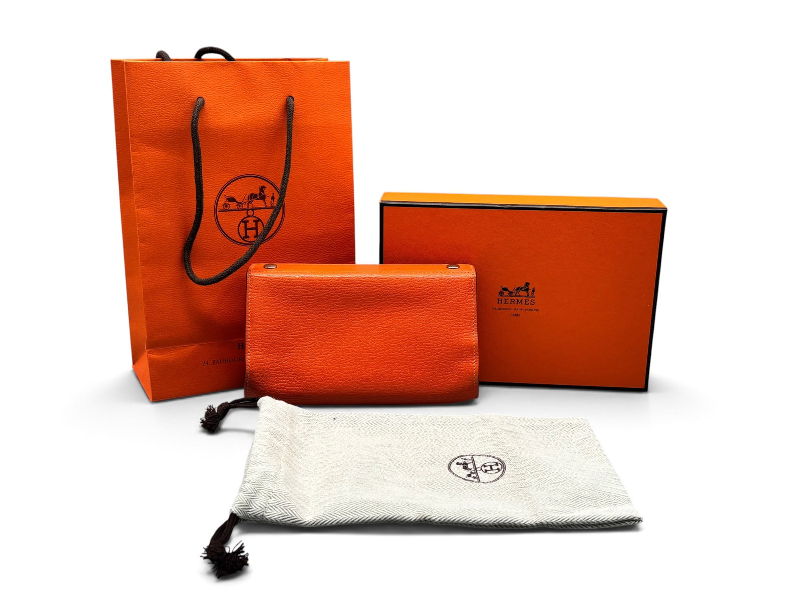 Hermes Karo Poppy Leather Pouch: An Hermes Karo leather pouch in orange-poppy with palladium silver-toned snap closure hardware. Marked Hermes. Includes Hermes box, dust cloth, and bag. 4in tall x 6in wide. | You have additional ship