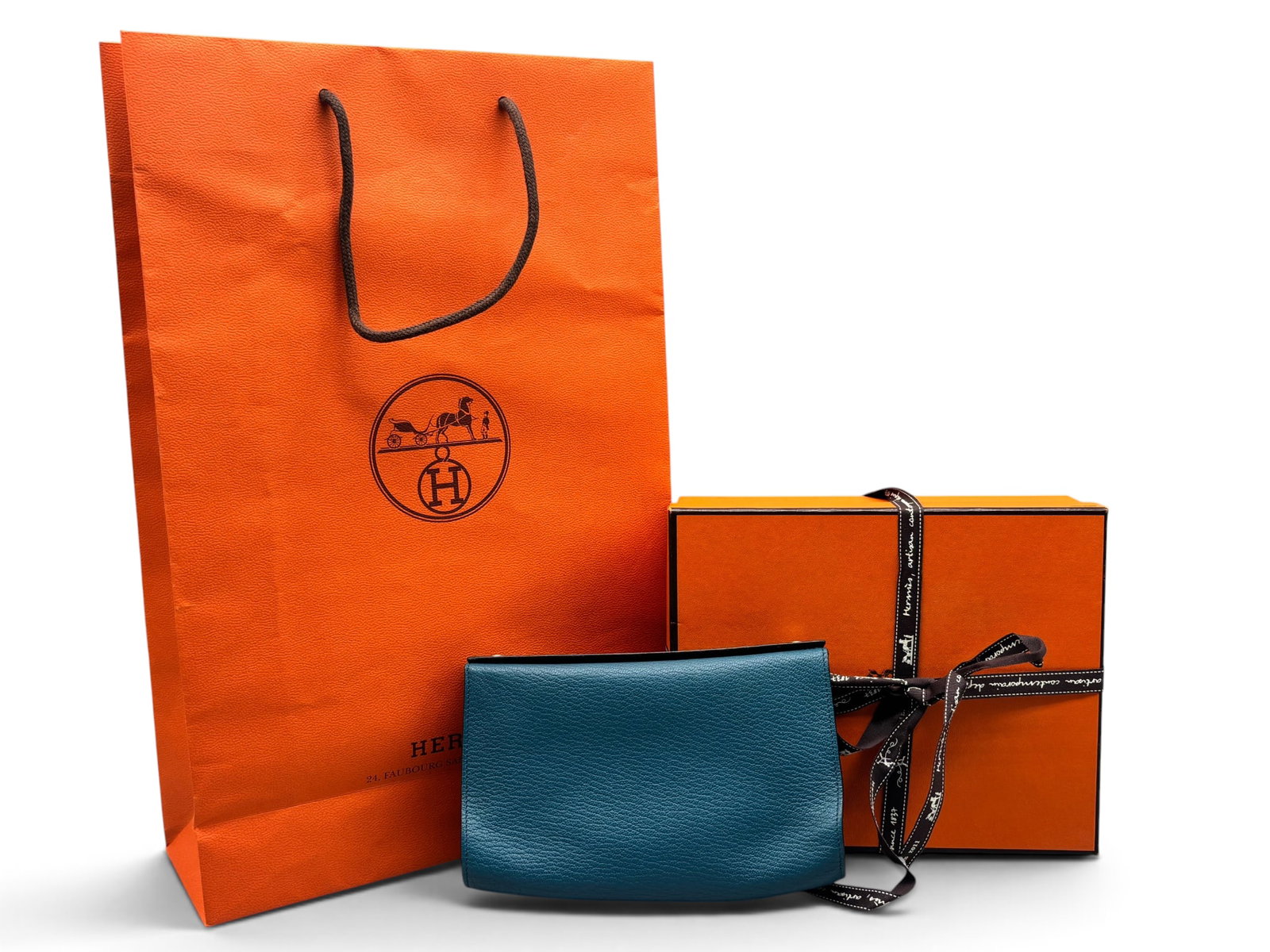Hermes Karo Blue Jean Leather Pouch: An Hermes Karo leather pouch in blue jean with palladium silver tone snap closure. Marked Hermes on hardware and on interior. Includes Hermes box, ribbon and bag. 5-1/2in tall x 7-1/2in wide. | You ha