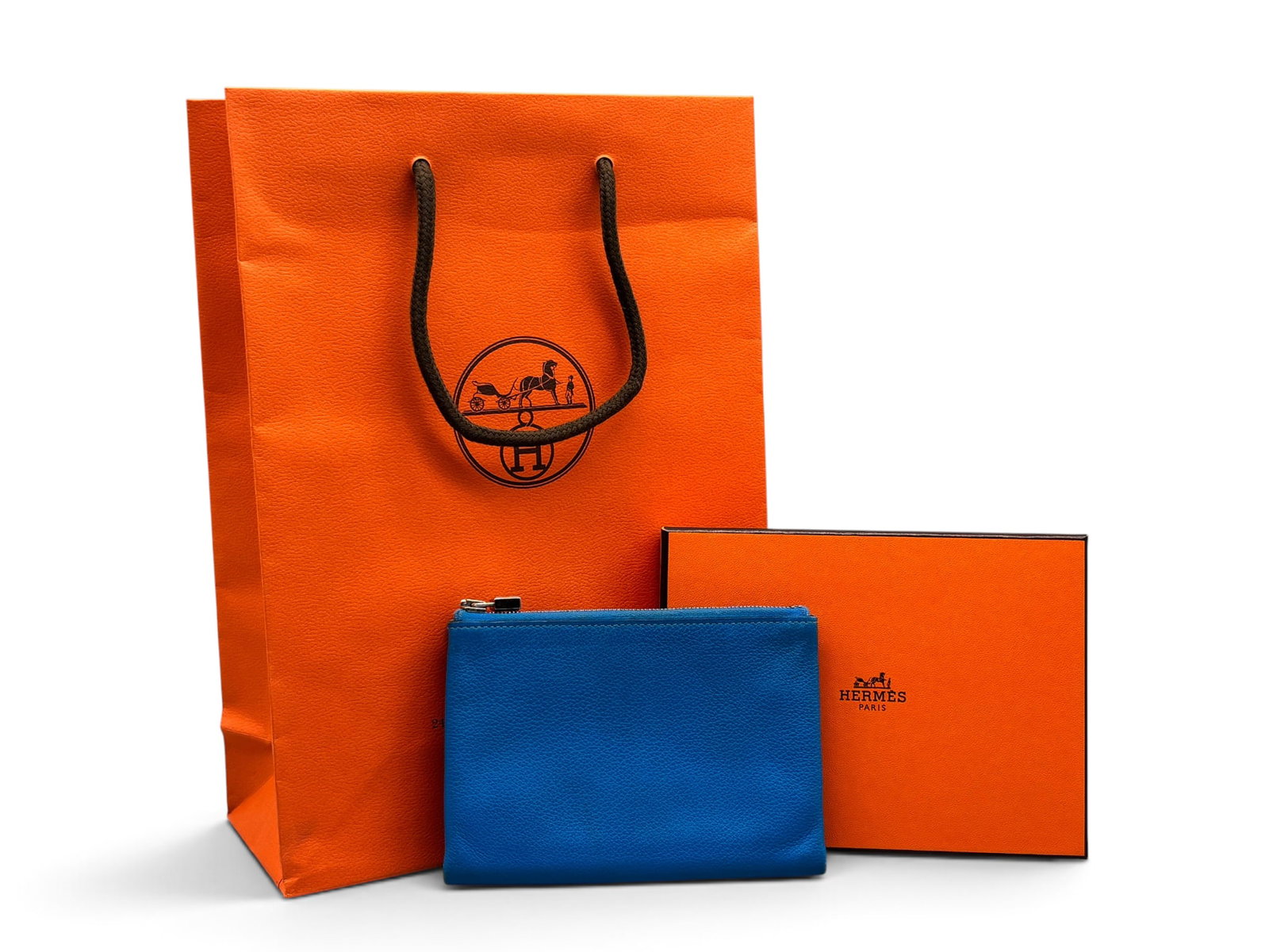 Hermes Cobalt Blue Leather Pouch: An Hermes Paris cobalt blue leather pouch with palladium zip closure and teal leather interior. Marked Hermes. Includes Hermes box and bag. 4in tall x 5-1/2in wide. | You have additional shipping opti