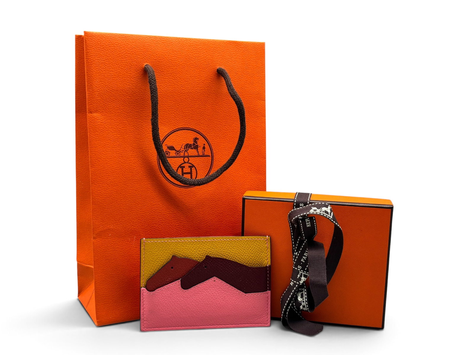 Hermes Les Petits Chevaux Card Holder: An Hermes Les Petits Chevaux card holder with multicolor leather horse design. Marked Hermes verso. Includes Hermes box, ribbon, and bag. 3in tall x 4in wide. | You have additional shipping options, a