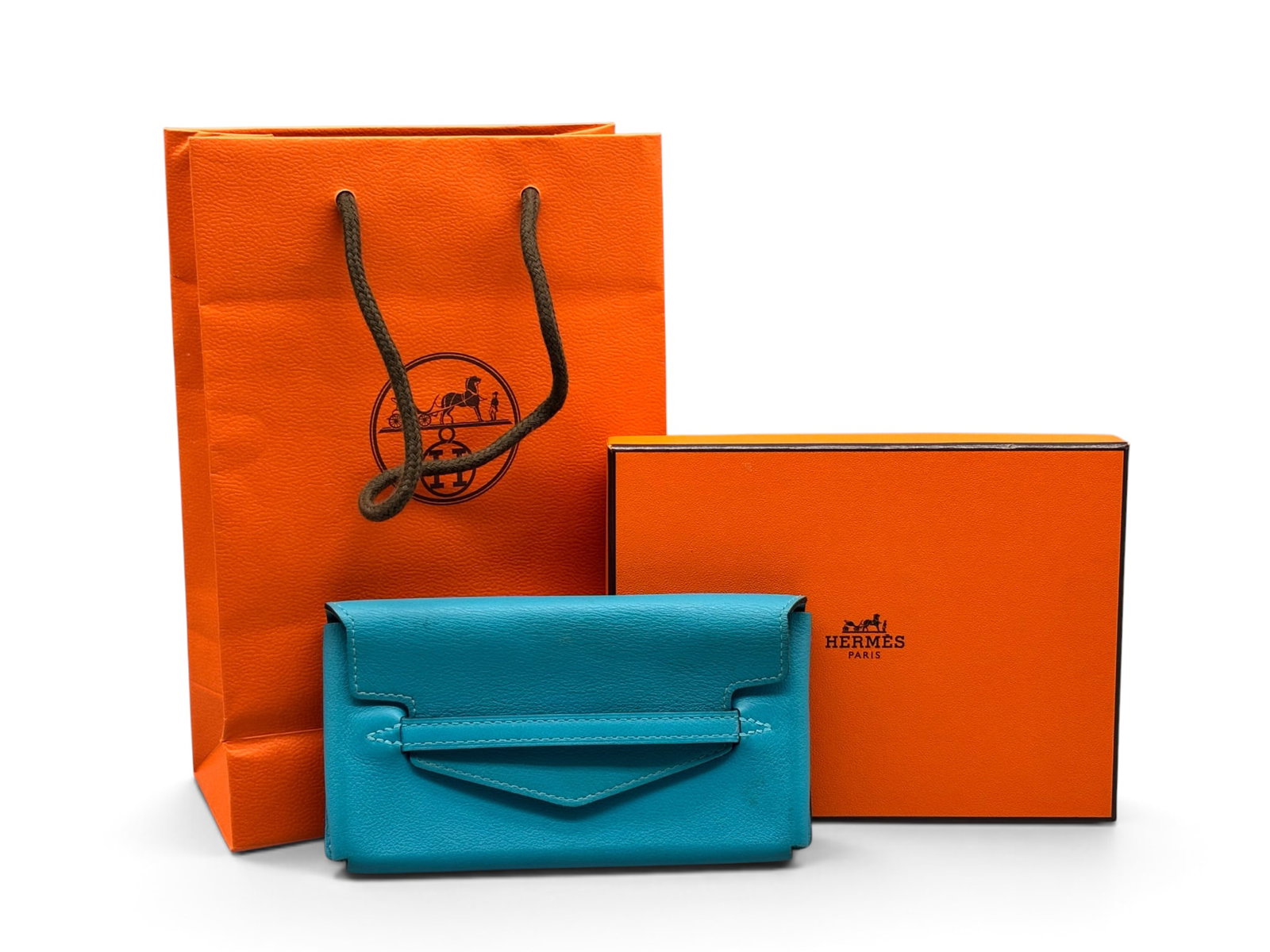 Hermes Turquoise Smart Pochette: An Hermes Paris Smart Pochette in 7B Turquoise Veau swift leather of envelope form with pull through closure. Marked Hermes. Includes original Hermes box, bag and receipt circa 2014. 3in tall x 6in wi