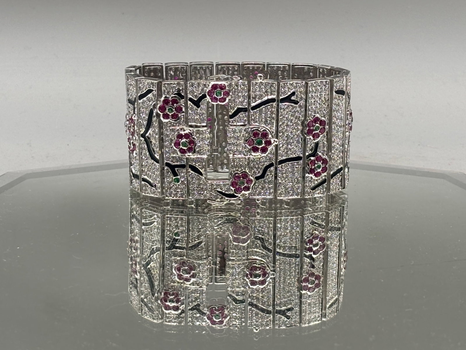 Jarin Sterling Cherry Blossom Bracelet: A Jarin sterling silver wide link bracelet studded with rhinestones in a cherry blossom design with enameled branches. Signed. 7-1/2in long. 79.67 dwt. | You have additional shipping options, and are 