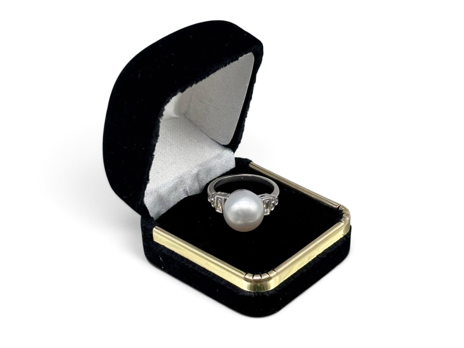 Platinum Diamond and Pearl Ring: A platinum ring with a large central 11mm pearl flanked by two baguette cut diamonds and six round cut diamonds. Tests as platinum. Size 7. 5.07 dwt. | You have additional shipping options, and are no