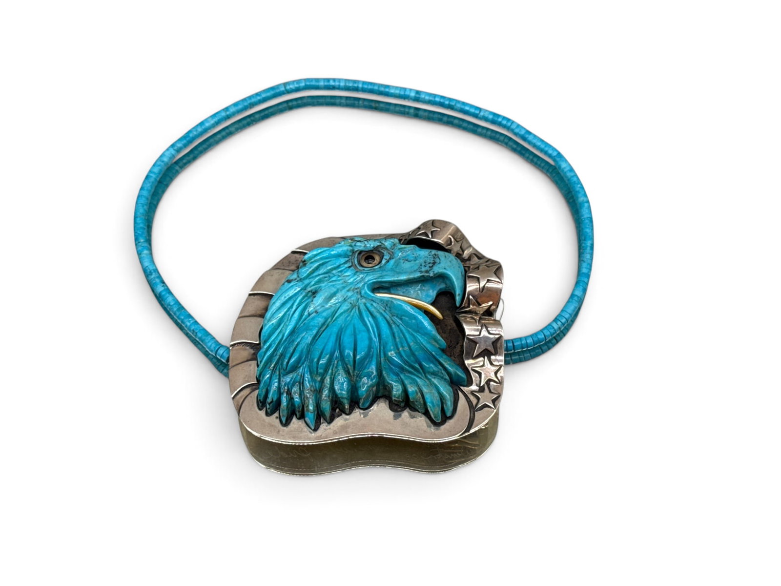 John Winston Sterling and Turquoise Eagle Belt Buckle: John Winston (American, 20th C.) A sterling silver-mounted, carved turquoise eagle head belt buckle with mother of pearl tongue, on a custom turquoise bead loop. Signed and inscribed verso. Dated 2008