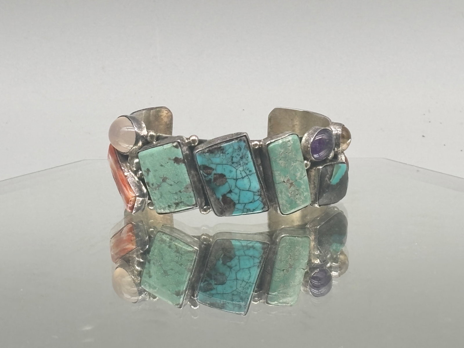 Lee Bennett Navajo Sterling and Turquoise Cuff: A Lee Bennett Navajo sterling silver cuff with inset turquoise, coral and onyx stones. Signed and marked sterling. 1in tall x 2-1/4in wide. 34.20 dwt. | You have additional shipping options, and are n