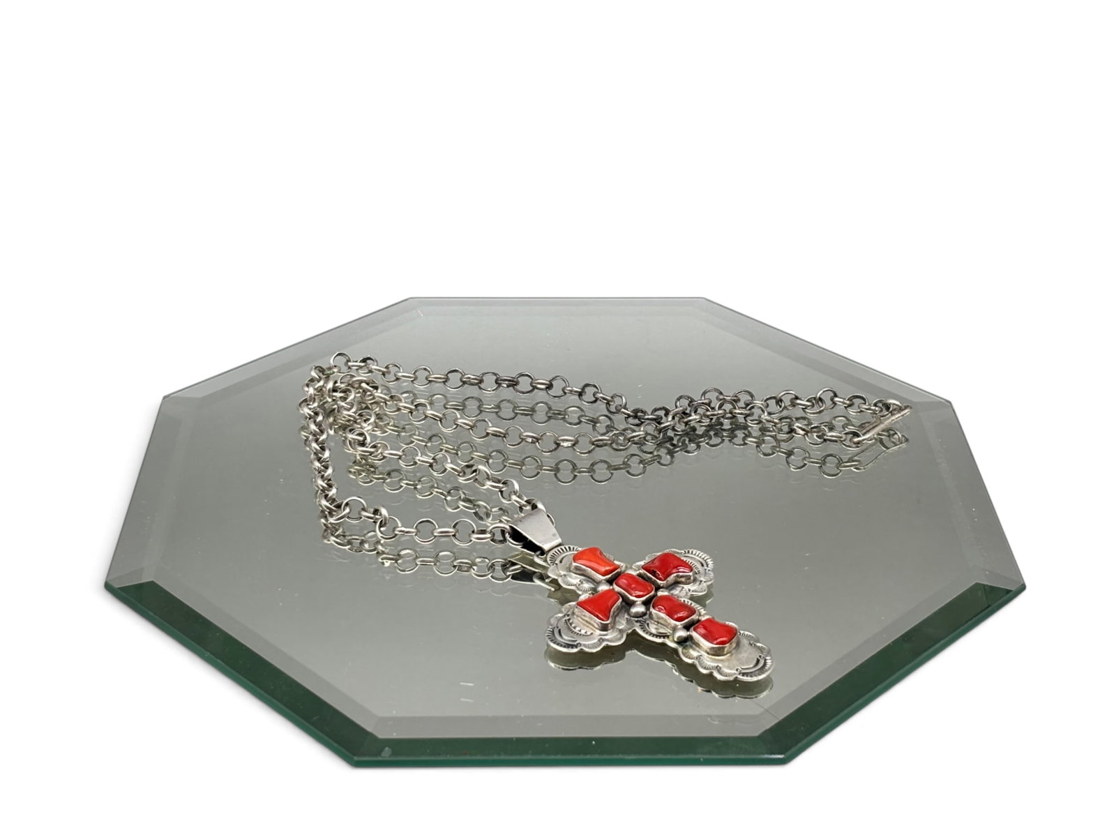 John Nelson Navajo Sterling and Coral Necklace: A John Nelson Navajo sterling silver chain necklace and worked cross-form pendant with inset coral stones. Signed and marked sterling verso. 24in long. Pendant: 3in tall x 2in wide. 38.51 dwt. | You h
