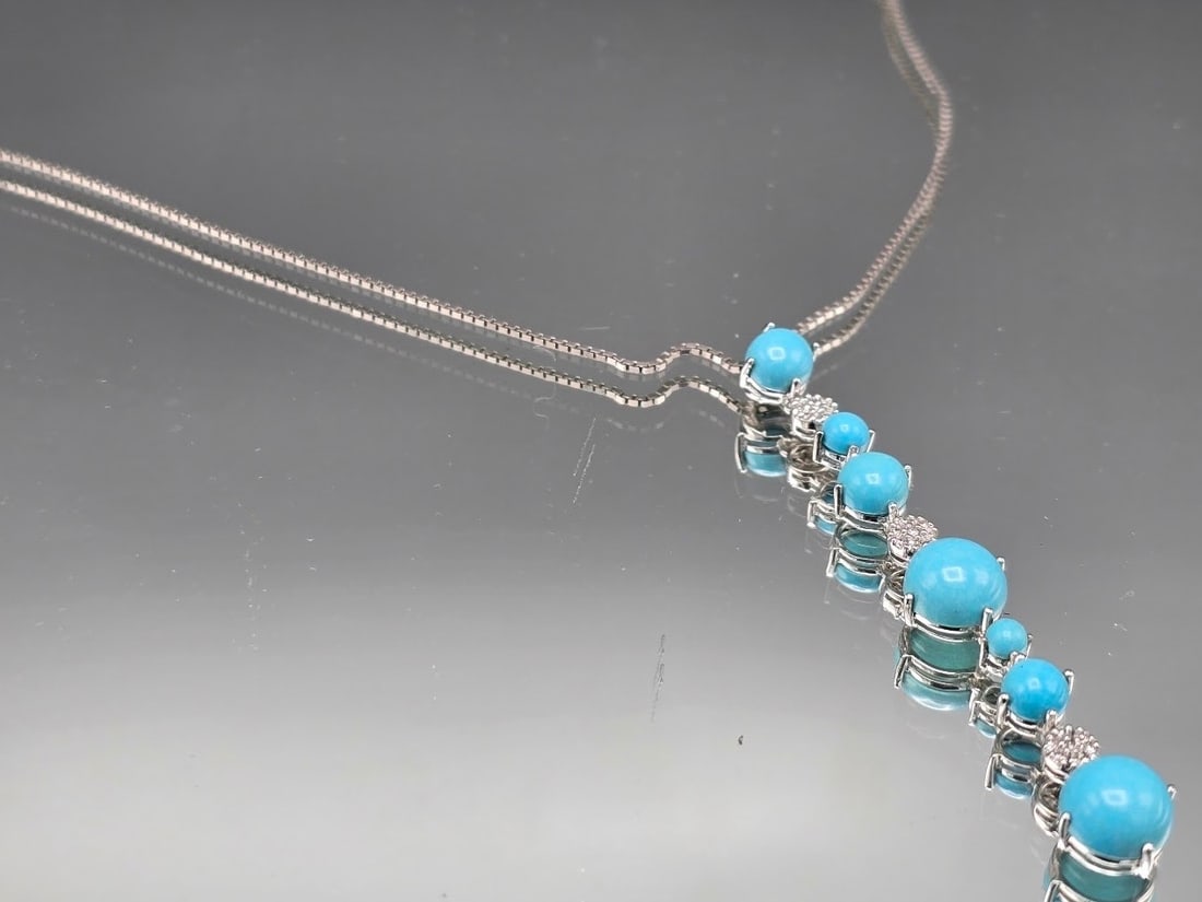 Le Vian 14K Turquoise Cascade Pendant Necklace: A Le Vian 14K white gold box chain and pendant set with in-line turquoise cabochons interspersed with pave diamond clusters. Marked Le Vian, 14K. Necklace 16in long. Pendant: 2-1/2in long. 4.11 dwt. |