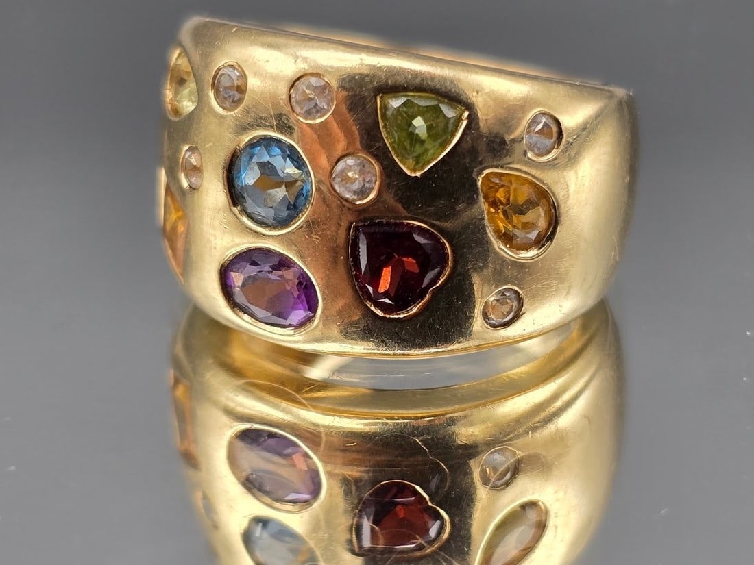 14K Multi Gemstone Domed Statement Ring: A 14K yellow gold dome ring with shaped aquamarine, garnet, chrysoprase, amethyst and tourmaline. Marked 14K. Size 7-1/4. 6.17 dwt. | You have additional shipping options, and are not required to use 